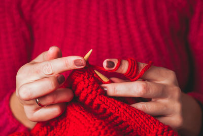 Close-up of hand holding red hands