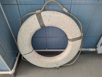 One white lifebuoy next to the pool