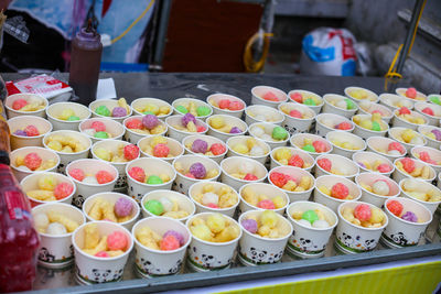Closeup of ice cream cups with colorful cakes in the market in vietnam