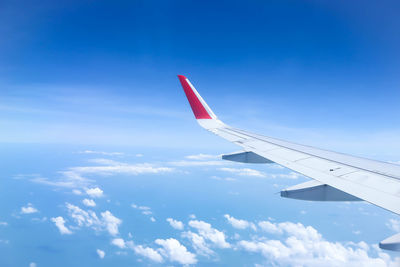 Aerial view of airplane flying in sky