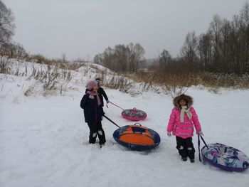 Children on snowy field during winter