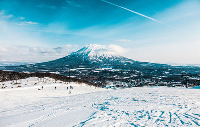 Scenic view of snowy field against mountain
