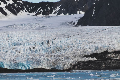 Scenic view of frozen sea against mountain