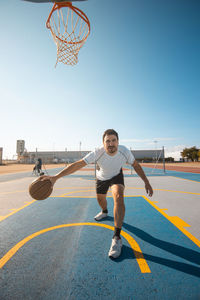 Full length of boy playing basketball