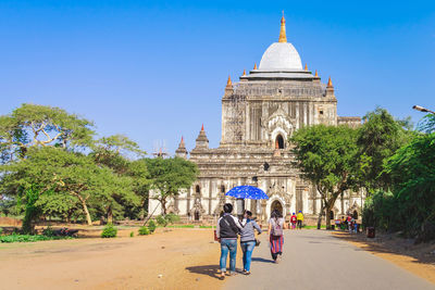 People walking in front of historical building