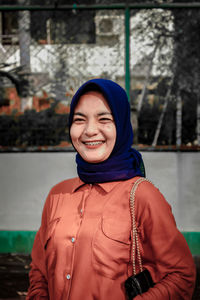 Portrait of smiling man standing in snow