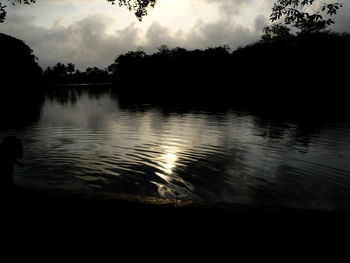 Scenic view of lake against sky at sunset