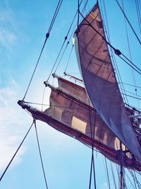 Low angle view of sailboat sailing on blue sky