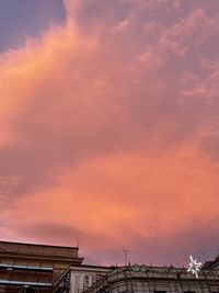 Low angle view of buildings against sky during sunset