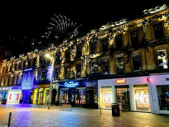 Low angle view of illuminated buildings at night