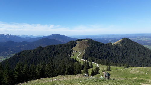 Panoramic view of mountain range against blue sky