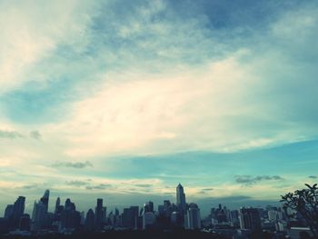 Cityscape against cloudy sky