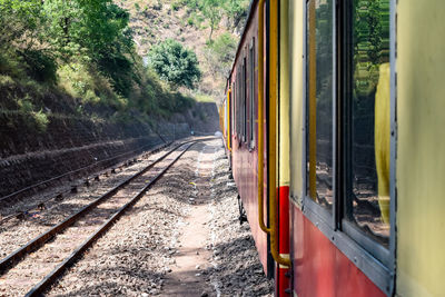 Toy train moving on mountain slopes, beautiful view forest, toy train from kalka to shimla in india