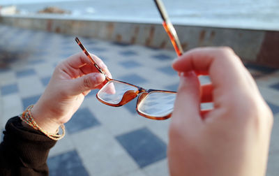 Close-up of woman holding glasses