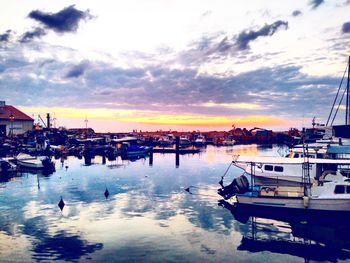 Boats in harbor at sunset