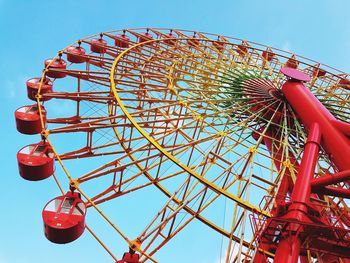 Low angle view of ferris wheel against sky