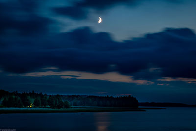 Scenic view of sea against sky at night