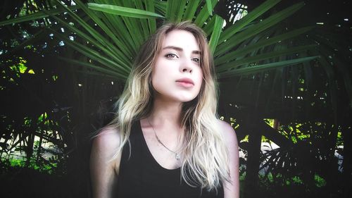 Close-up of young woman against tree