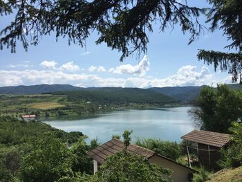 Scenic view of lake and mountains against sky