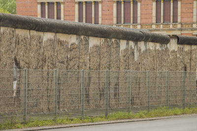 Fence on field by wall