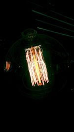 Close-up of illuminated light bulb