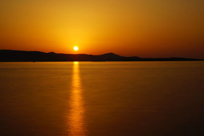 Scenic view of sea against romantic sky at sunset