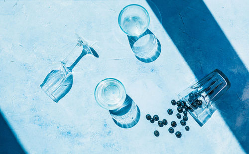 High angle view of bottles on glass table