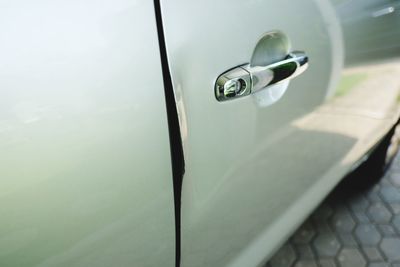 Close-up of dent on car door