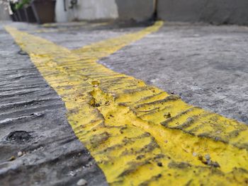 Close-up of yellow marking on footpath