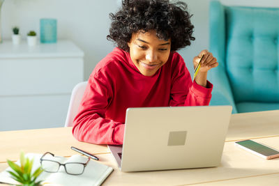 Young woman using laptop at home