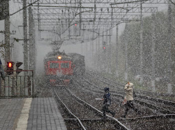 View of railroad tracks in city during winter