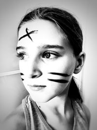 Close-up portrait of young woman against wall
