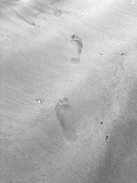 High angle view of footprints on sand