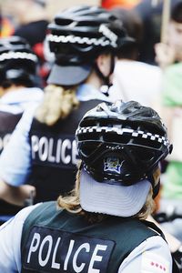 Rear view of women police on street