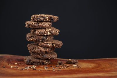 Close-up of stack on table against black background