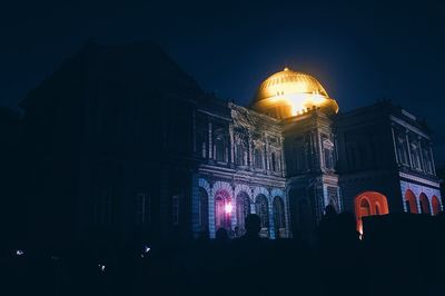 Low angle view of illuminated cathedral against sky at night