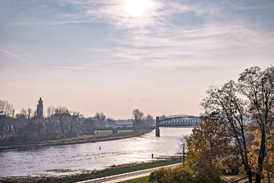 Bridge over river with city in background