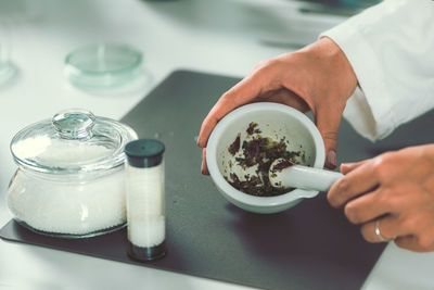 Cropped image of female chef preparing food in commercial kitchen