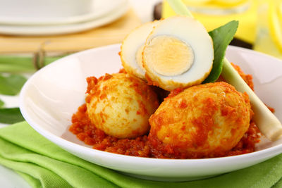 Close-up of spicy eggs in plate on table