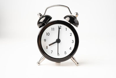 Close-up of clock tower against white background