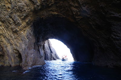 Scenic view of sea seen through cave