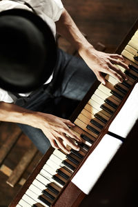 Above view of a man playing the piano. high angle of the hands of a man playing a musical instrument