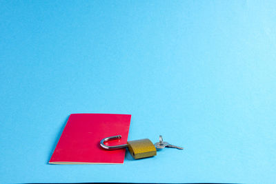 High angle view of telephone booth on table against blue background