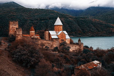 Castle by lake and mountains