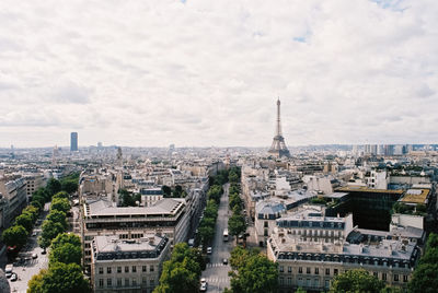 High angle view of buildings in city against cloudy sky