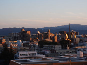 Cityscape against sky during sunset