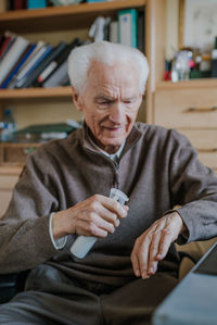 Midsection of man sitting on seat