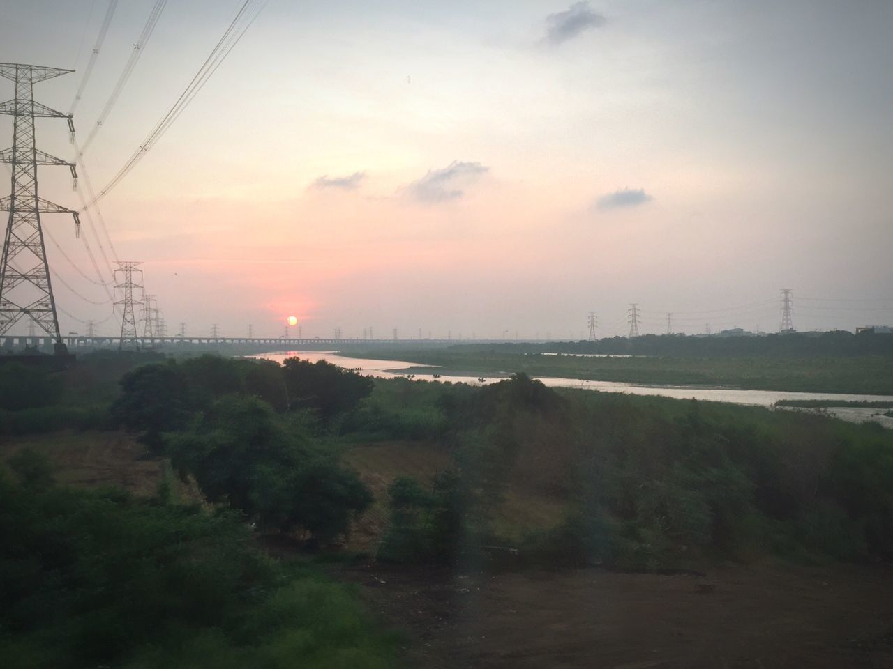 sunset, electricity pylon, power line, sky, tranquil scene, tranquility, scenics, water, electricity, landscape, beauty in nature, nature, connection, power supply, fuel and power generation, cloud - sky, idyllic, field, orange color, tree