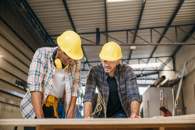 Rear view of man working at construction site