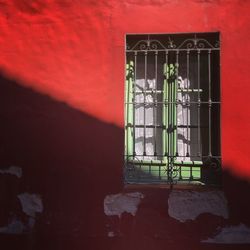 Close-up of window on red wall